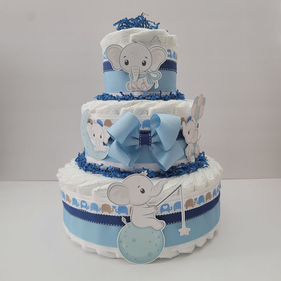 Baby Elephant diaper cake for a boy with three tiers, light blue ribbons and bow, and baby elephant cutouts holding a balloon