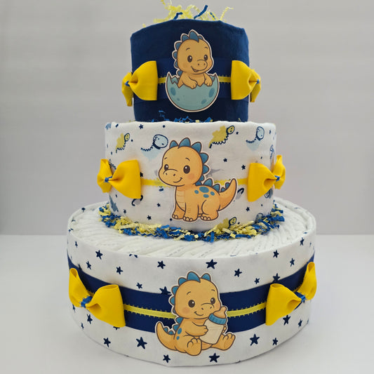 "Handmade baby dinosaur diaper cake with plush dino toy, green ribbon, and diapers, perfect baby shower centerpiece or gift"
