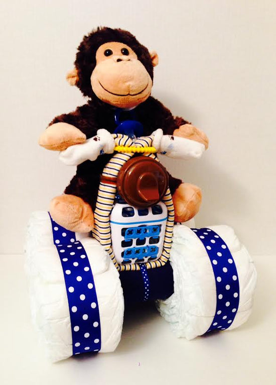 Monkey on a Quad diaper creation for a boy: a plush monkey riding a four-wheeler built from rolled diapers with navy polka dot wheels